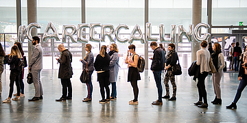 People standing in line in front of a "Career Calling" sign